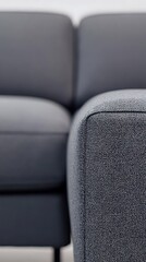 A black couch with a gray and white pattern on it