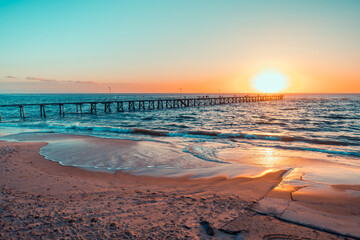 People silhouettes on Port Noarlunga jetty at sunset, South Australia