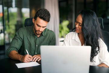 Two happy diverse multiethnic business team people working, talking in corporate office
