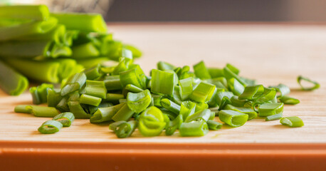  chop fresh green onion on a cutting board close-up