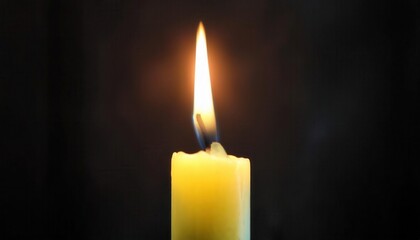 glowing candle flame against dark background with soft light halo, symbolizing warmth, spirituality, remembrance, and serenity