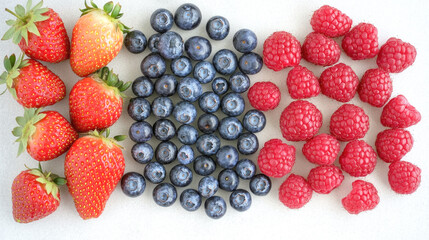 Fresh strawberries, blueberries, and raspberries on white background