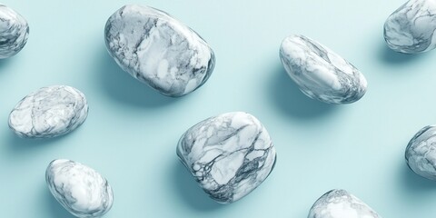 Floating polished marble stones with gray veining on a light blue background