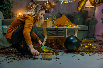 Woman cleaning confetti after birthday party celebration