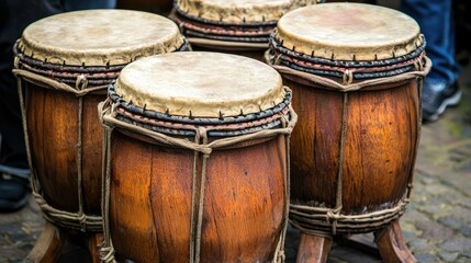 Four antique drums on cobblestones