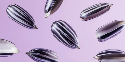 Floating sunflower seeds with smooth black-and-white shells on a pastel purple background