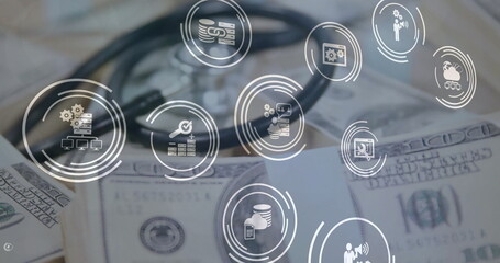 Image of business icons over stethoscope and banknotes