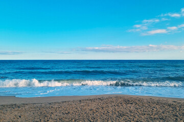 Serene Ocean View with Sandy Beach Under Clear Blue Skies for Relaxation and Tranquility