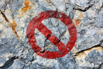 Red prohibition symbol on a textured rock surface in nature