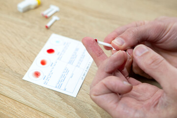 Blood typing test being performed, showing results on card, focusing on health and diagnostics,...