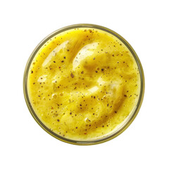 Creamy yellow smoothie with hints of spices in a clear glass bowl isolated on a white background