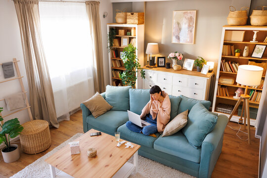 Woman consulting online doctor while sick at home