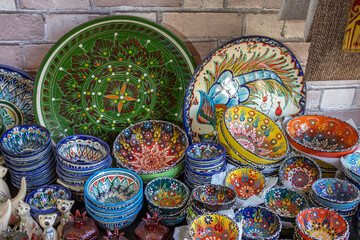 Multicolored ceramic plates with oriental patterns. Ceramics at the oriental bazaar. The china...