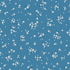 Vector illustration. Ditsy Floral seamless pattern of delicate tiny white flowers on a blue background, blooming flowers. Liberty pattern for textiles, packaging, fabric, sublimation printing