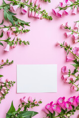 Obraz premium Vertical Foxgloves pink background. Festive holiday greeting card for Birthday, Woman or Mothers Day, blank copy paper and a greeting card. View from above.