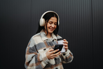 Portrait of a teenage girl smile and send text message sms with cellphone	
