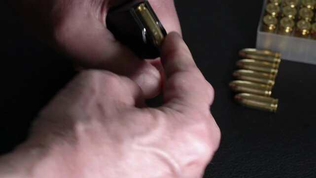 Magazine of 9mm pistol is being loaded. 