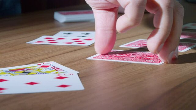 Hand turning cards, slow motion