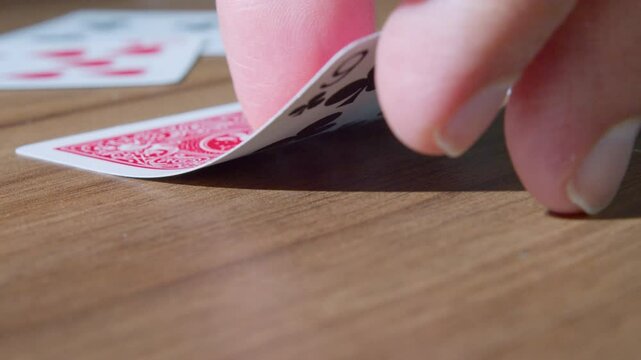 Hand turning cards, slow motion