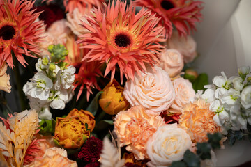 Vibrant mixed flower bouquet with spiky orange and soft white roses