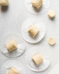 Overhead view of steamed bun dough on a white countertop, top view of mantou dough, process of making steamed milk buns