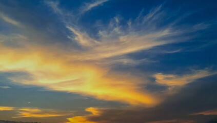 Obraz premium Reflection of sunrise in clouds. The sunset rays of the sun illuminate the sky.