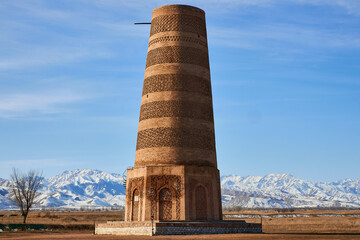Burana Tower, minaret of Karakhanid state. Touristic place, Kyrgyzstan travel landmark. Ruins of...