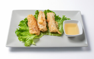 Vietnamese rolls  stuffed with chicken and vegetable asian food recipe served with sauce on a plate with a white background