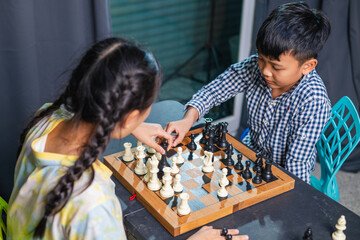 Smart kids enjoying a board game, making their next move in a friendly chess match.