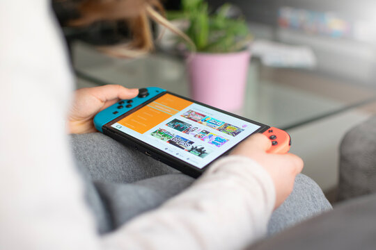 Girl playing with her Nintendo Switch video game console.