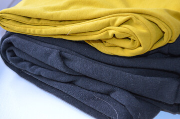 stacked fabric yellow black fashion sustainability material quality textile industry clothing...