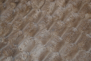 plush textured fabric in a warm beige or camel color material ultra-soft raised ribbed pattern cozy blankets throws winter luxury comfort home decor interior design cold-weather fashion tactile relax