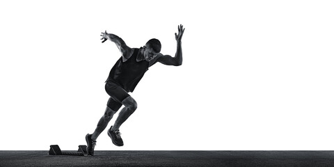 Dynamic photo of young athletic man, sprinter running from start line against white background....