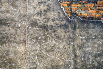 Cracked Concrete Wall with Exposed Brick Texture and Patterns