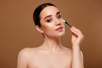 Obraz premium Stunning perfect lady model have morning routine prepare for event apply tone foundation on face with brush
