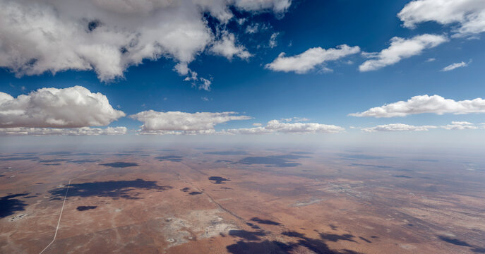 bright clouds cast shadows over sparse farms in desert countryside, near Kuzikus Reserve,  Namibia