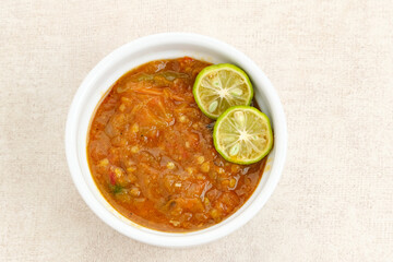 Sambel or Sambal Tomat, made from tomatoes, chilies, salt, sugar, garlic, shallots and shrimp paste (terasi). Indonesian food.
