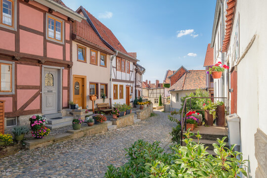 Quedlinburg, Germany &ndash; August 29, 2024: The streets of the Quedlinburg city district of the M&uuml;nzenberg feature many picturesque half-timbered houses. It is also part of the UNESCO World Heritage.