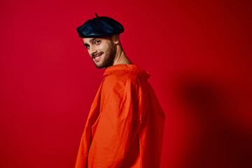 Romantic young man showcases stylish fashion in vibrant studio setting