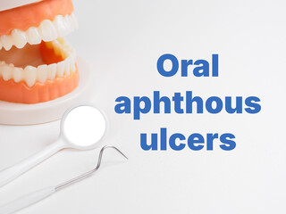 "Oral aphthous ulcers" inscription title on dental background