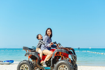 Asian kid and mom riding ATV at in Xunliao Bay, Huizhou city, Guangdong Province, China, during January © sweetriver