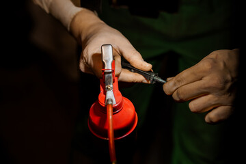 Close-up of Technician's Hands Repairing Mechanical Part with Precision at Workshop