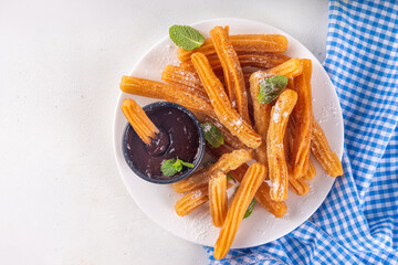 Churros with sugar powder and chocolate