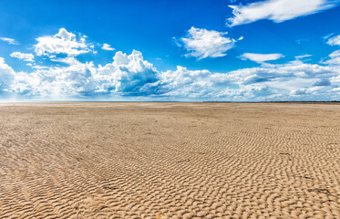 ripples on sandy beach at low tide