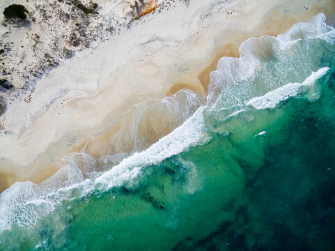 aerial view of waves washing up onto a beach