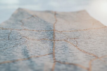 close-up photo captures intricate texture of vintage road map softly lit to reveal detailed highways intersections