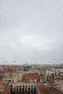 View through the rain-soaked window, Barcelona city skyline view