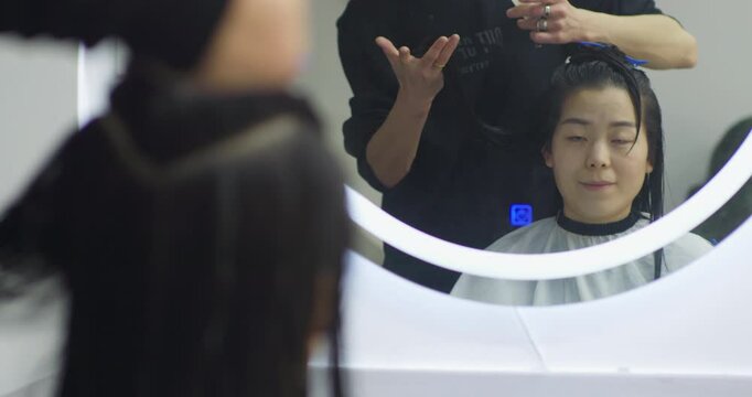 Barber trims Chinese woman's hair