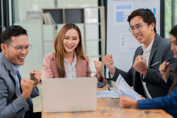 A group of successful businesses celebrate their success at the office during an ESG meeting, presenting information on company growth and marketing strategies. Colleagues applaud and cheer