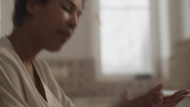 Black woman singing solfeggio music along with daughter at table